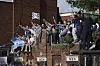 Tottenham Hotspur fans gather on rooftops to get a better view of the players during the victory parade on May 23. [AP/YONHAP]