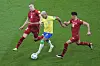 Brazil's Richarlison, center, is challenged by Serbia's Strahinja Pavlovic, left, and Sasa Lukic during the World Cup group G football match between Brazil and Serbia, at the the Lusail Stadium in Lusail, Qatar on Thursday. Brazil beat Serbia 2-0 with Richarlison scoring both goals in the second half of the match. [AP/YONHAP]