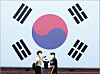 People take a photo in front of a large Korean flag at Seodaemun Prison History Hall in western Seoul, ahead of this year’s Liberation Day on Aug. 15. [YONHAP]