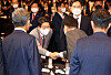 President Yoon Suk-yeol, right, shakes hands with Kweon Seong-dong, the floor leader and acting chief of the People Power Party, at a forum at the Shilla Hotel in central Seoul Wednesday. [YONHAP]