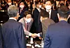 President Yoon Suk-yeol, right, shakes hands with Kweon Seong-dong, the floor leader and acting chief of the People Power Party, at a forum at the Shilla Hotel in central Seoul Wednesday. [YONHAP]
