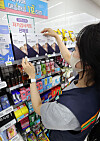A store employee stacks Covid-19 self testing kits at a 7-Eleven store in central Seoul on Wednesday. The number of people confirmed to have contracted Covid-19 reached the second-highest daily figure on Tuesday, raising concerns that the Delta variant is spreading rapidly in Korea. [YONHAP]