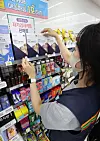 A store employee stacks Covid-19 self testing kits at a 7-Eleven store in central Seoul on Wednesday. The number of people confirmed to have contracted Covid-19 reached the second-highest daily figure on Tuesday, raising concerns that the Delta variant is spreading rapidly in Korea. [YONHAP]