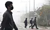 Commuters walk through smog on Tuesday as the comprehensive air quality index reached 'bad' levels in Sejong. [NEWS1]