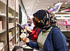 Foreigners look at Korean cosmetic products at an Olive Young store in Seoul. [YONHAP]