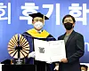June Huh, right, a Korean-American mathematician and professor of mathematics at Princeton University who became the first person of Korean descent to receive the Fields Medal earlier this year, accepts the 'Proud Seoul National University Alumni' award from the university's president Oh Se-jung during the graduation ceremony held on the campus in Gwanak District, southern Seoul, on Monday. [YONHAP]