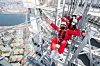 Customers take the Sky Bridge Tour at the Lotte World Tower in southern Seoul. The tour, which involves walking across a bridge 54 meters (177 feet) in the air, reopened after it was halted in the winter, Lotte Shopping said Thursday. [YONHAP]