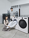 Models demonstrate how to use the latest LG Tromm washing machine and dryer on Monday. The new appliances are said to wash and dry clothes more efficiently. They will be showcased at CES 2022 in January next year. [LG ELECTRONICS]