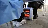 The medical staff at a Covid-19 testing center in Mapo District, western Seoul, warm their feet by an electric heater on Monday morning. [YONHAP]