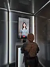 A visitor tries out the “AI Care Call” service at Naver’s pavilion inside the “Festival Station” of the 2025 World Expo in Osaka, Japan, on July 10. [KANG KWANG-WOO]