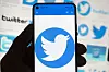 The Twitter logo is seen on a mobile phone. [AP]