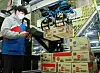 A CJ Logistics employee operates robotic arms to move around boxes at one of the logistics company's warehouses. The company on Thursday announced the commercial use of the artificial intelligence-operated robotic system in its conveyor line. [CJ LOGISTICS]
