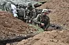 Ukrainian servicemen stand in a trench near their position near the town of Bakhmut, Donetsk region in Ukraine on Saturday, amid the Russian invasion of Ukraine. [AFP/YONHAP]