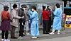 People stand in line to get tested for Covid-19 at a testing center in Busan on Sunday. [JOONGANG ILBO]