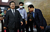 Rep. Youn Kwan-suk, right, bows to Democratic Party leader Lee Jae-myung as he passes in the National Assembly in Yeouido, western Seoul on Monday. [YONHAP]