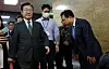 Rep. Youn Kwan-suk, right, bows to Democratic Party leader Lee Jae-myung as he passes in the National Assembly in Yeouido, western Seoul on Monday. [YONHAP]
