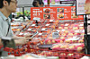 Boxes of peaches selected by an AI system are on display for sales at a Lotte Mart's Seoul Station branch in central Seoul on Thursday. The AI system takes three to four photos of the peaches per second on a conveyor belt to sort out the damaged ones. [YONHAP]