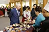 Charles speaks with the Korean Ambassador to Britain Yoon Yeo-cheol and members of the local Korean community to hear about Korea's culture and cuisine in New Malden, England, on Wednesday. [AP]