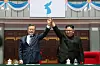 South Korean President Moon Jae-in, right, and North Korean leader Kim Jong-un hold hands after watching a large-scale gymnastic and artistic performance at the May Day Stadium in Pyongyang on Sept. 19, 2018. [YONHAP]