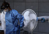 A medical staffer cools off at a Covid-19 testing site in Jeonju, North Jeolla, Thursday, as the coronavirus spreads. [NEWS1]