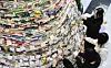 Students attach handwritten wishes to a Christmas tree made out of books at Changpa Library on Daegu University’s Gyeongsan campus on Dec. 16. [YONHAP]
