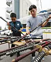 Police examine illegal weapons in front of the Suwon Nambu Police Station in Gwonseon District in Suwon, Gyeonggi, on Monday. The National Police Agency has designated Monday to Sept. 30 as a period for voluntarily reporting illegal weapons in collaboration with the Ministry of National Defense and the Ministry of the Interior and Safety. [NEWS1]