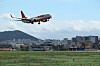 A Jeju Air flight attempts a go-around due to strong wind at Jeju International Airport on Tuesday morning. [YONHAP]