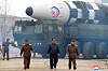 North Korean leader Kim Jong-un, center, walks forward in what appears to be a staged photo-op released by the state-run Korean Central News Agency (KCNA) on the occasion of the test launch of an intercontinental ballistic missile on Thursday. Kim is flanked on his right by Jang Chang-ha, chief of the North's National Academy of Defense Science, and Kim Jong-sik, chief of the Workers' Party Military Industry Department on his left. [YONHAP]