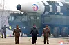 North Korean leader Kim Jong-un, center, walks forward in what appears to be a staged photo-op released by the state-run Korean Central News Agency (KCNA) on the occasion of the test launch of an intercontinental ballistic missile on Thursday. Kim is flanked on his right by Jang Chang-ha, chief of the North's National Academy of Defense Science, and Kim Jong-sik, chief of the Workers' Party Military Industry Department on his left. [YONHAP]