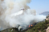A helicopter puts out a fire that has broken out on Mount Inwang in Jongno District, central Seoul on Sunday. [YONHAP]