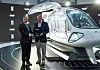 Hyundai Motor Group Chairman Euisun Chung, right, and Rolls-Royce CEO Warren East, standing next to an electric aircraft concept model made by Supernal that is expected to be introduced in 2028, pose for a photo after signing a memorandum of understanding to cooperate on the development of air mobility. [HYUNDAI MOTOR]