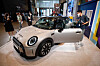 Customers check out a newly upgraded Mini Cooper displayed at State Tower Namsan in central Seoul on Wednesday. BMW Korea unveiled three new Mini cars — the Mini 3-door, Mini 5-door and Mini Convertible. The automaker will be holding a joint campaign with coffee franchise Starbucks under the slogan: ″We are different, but pretty good together.″ Korea is the only country where the two have collaborated. [NEWS1]
