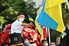 A young participant to a rally against Russian invasion of Ukraine in Seoul on May 29, 2022, hold up a flag of Ukraine. [YONHAP]