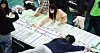 Election officials tally the proportional representation votes by hand after the April 10 general election in Daegu. [NEWS1]