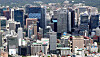 A view from Mount Namsan, central Seoul, of the headquarters of major Korean corporations in May. The leading corporations have been lowering total employee numbers. [YONHAP]