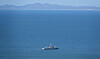 A South Korean Navy vessel patrols the area of the Northern Limit Line in the Yellow Sea in September 2020. The shoreline of North Korea's Hwanghae Province is visible in the distance. [YONHAP]