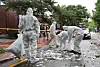 Staffers from local authorities clean the site where North Korea's trash-carrying balloons landed in Jung District, central Seoul, on Wednesday morning. [YONHAP]
