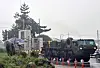 Military vehicles arrive Wednesday to clear up debris from the site where a Hyunmoo-2 missile crash landed the previous night. [NEWS1]