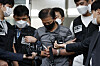 Kang Yun-seong, 56, who allegedly killed two women last month after cutting off his ankle monitor, is escorted out of Songpa Police Precinct and transferred to the Seoul Eastern District Prosecutors' Office on Tuesday morning. Kang faces six charges in total, including murder, violation of laws on parolee’s monitoring devices, robbery and fraud. The police said that Kang’s motives for murder stemmed from his financial issues. [NEWS1]
