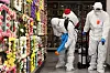 Workers disinfect a memorial hall in Suwon, Gyeonggi, on Wednesday, ahead of the Lunar New Year holidays, to help prevent further infections of Covid-19. [YONHAP]
