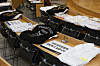 Collegiate jumpers and white gowns are placed on desks at a lecture hall at a medical college of Pusan National University on Tuesday. [YONHAP]