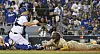 San Diego Padres shortstop Kim Ha-seong scores from third base on a sacrifice fly against Los Angeles Dodgers catcher Will Smith in the fifth inning during game one of the National League Divisional Series at Dodgers Stadium in Los Angeles on Tuesday. Kim hit a double and later came around to score in the 5-3 loss. [UPI/YONHAP]