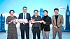 SK geo centric CEO Na Kyung-soo, center, and Bruno Guillon, chief commercial officer of Plastic Energy, second from left, take a photo at SK booth for the CES 2023 show. [SK GEO CENTRIC]