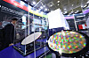Visitors examine a semiconductor wafer at the Semiconductor Exhibition held at Coex, Gangnam, in October. [NEWS1]