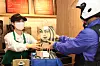 A Starbucks employee hands over a delivery order during a test ahead of the launch of the pilot program next week. [STARBUCKS KOREA]