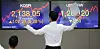 An employee stands in front of a screen with the closing Kospi at the dealing room in Hana Bank located in Jung-district, central Seoul, Tuesday. [YONHAP]