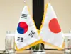 Flags of Korea, left, and Japan placed on the table as the two countries' defense ministry chiefs met in Singapore on June 4 [YONHAP]