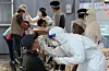 Foreign workers receive Covid-19 tests in Busan in March. [SONG BONG-GEUN]