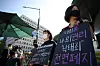 Protesters demand a complete lifting of a ban on abortions outside the National Assembly on Wednesday. Earlier in the morning, the government proposed to partially lift the ban. [YONHAP]