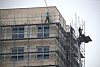 Workers work without safety harnesses at a construction site in Seoul in February. [YONHAP]